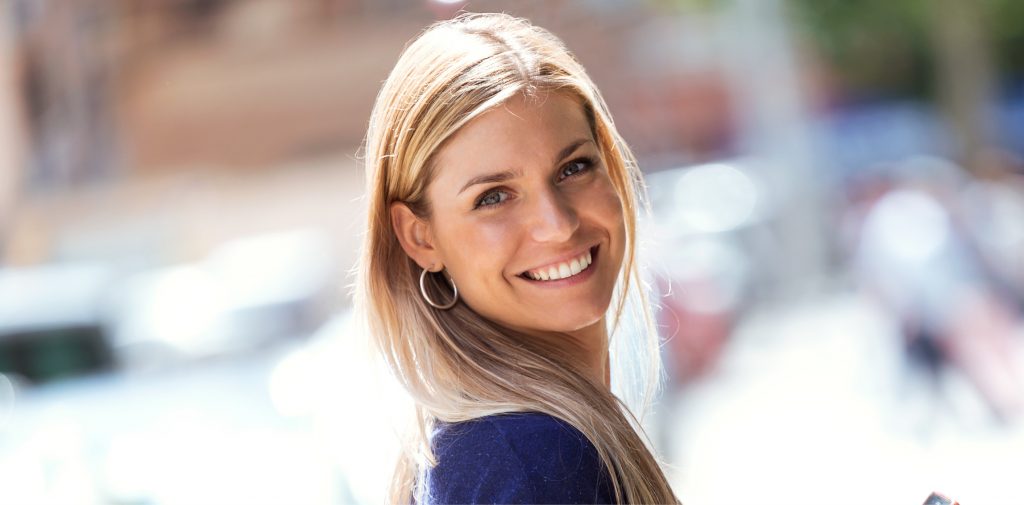 Blonde women smiling outside